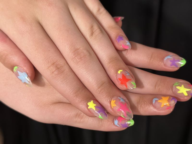 Short manicure with neon star accents