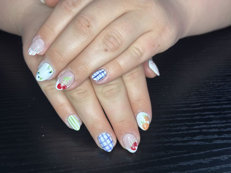 Gingham and fruit nail art on a short set